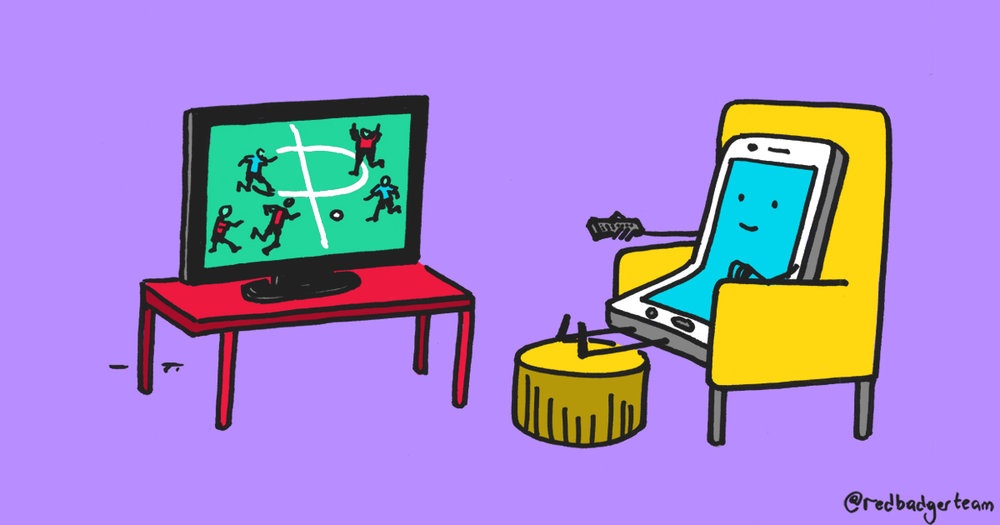 A colourful illustration of a smiling phone sat like a human in an armchair watching the football on TV.